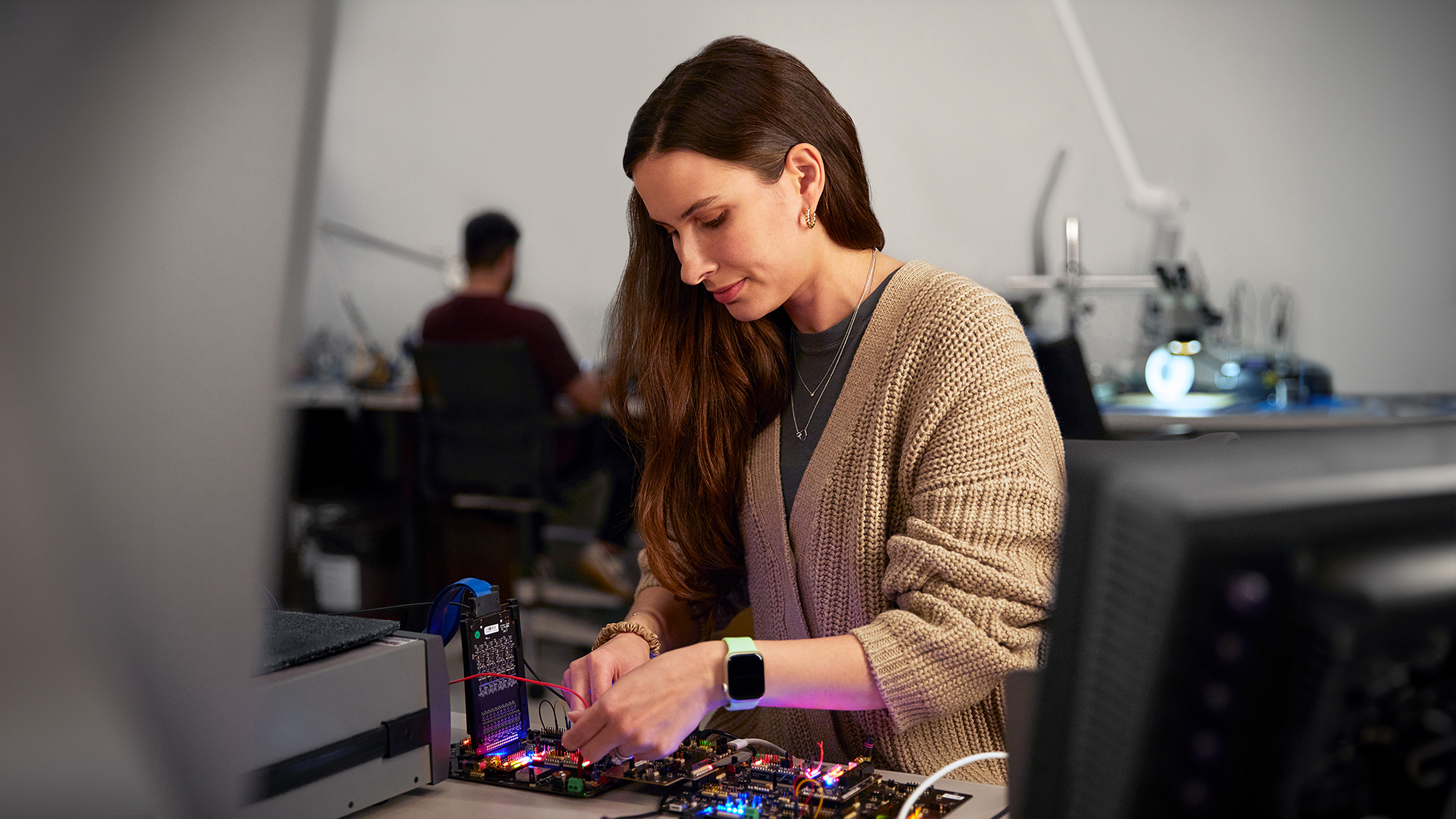 An Apple engineer testing hardware in a lab.