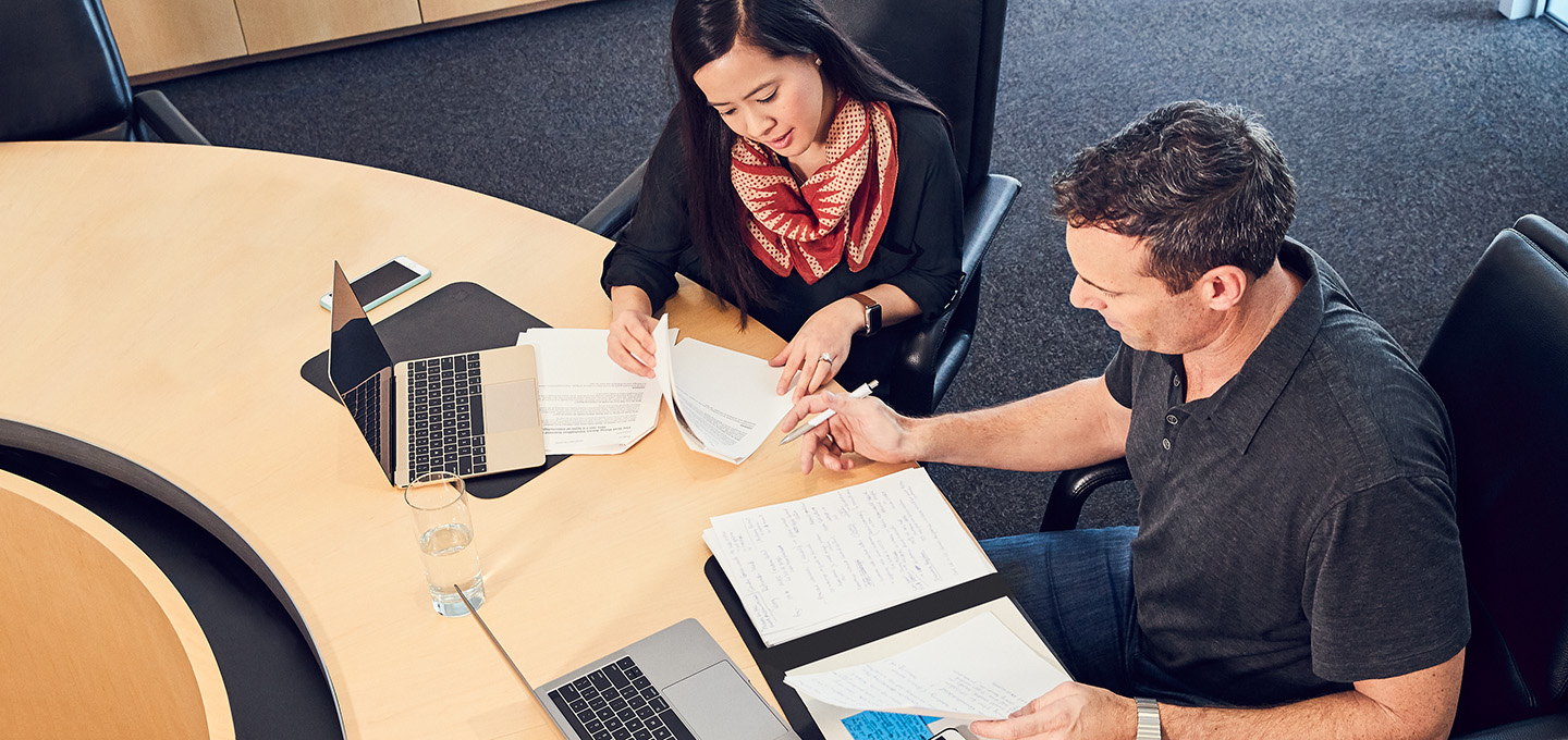 Apple sales employees collaborate on a project