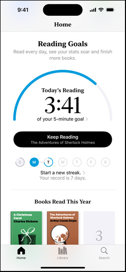 iPhone screen showing the Reading Goals interface in the Books app. At the top, there is a progress ring. Below the progress ring is the weekly reading streak tracker. At the bottom is the Books Read This Year section, which includes a row of two books, with an empty slot for a third