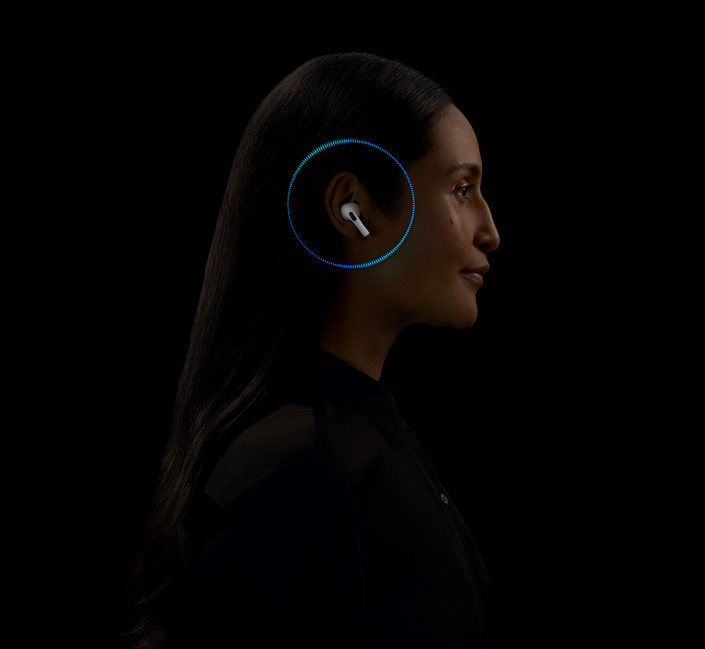 A person wearing AirPods Pro 2 with soundwaves around their ear.